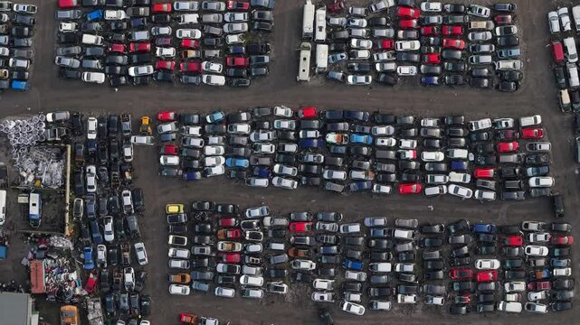 Aerial view of car scrap yard in Kildare, Ireland showing rows of abandoned vehicles