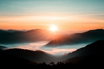 Fototapeta premium Mountain landscape at sunrise with mist and vibrant colors illuminating the sky