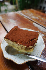 Tiramisu cake on wooden table