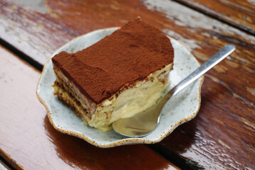 Tiramisu cake on wooden table