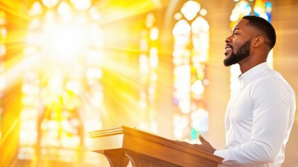 A Black male preacher in a white shirt delivers a sermon at a podium with sunlight streaming through stained-glass windows, symbolizing faith and spirituality.
