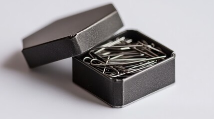 Staples (Box of Staples): A box of small metal staples, neatly packed with a few staples visible, isolated on a white background.