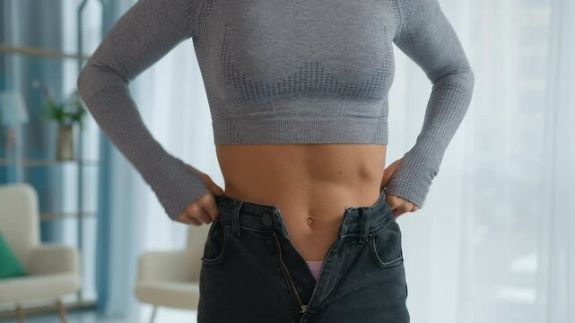 Frustrated Woman Putting on Tight Jeans