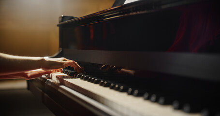 Close Up on Pianist Hands Playing an Exciting Jazz Melody on a Black Grand Piano. Anonymous Artist is Focused on Creating Beautiful Instrumental Song as She Practicing Playing on a Keyboard © Gorodenkoff