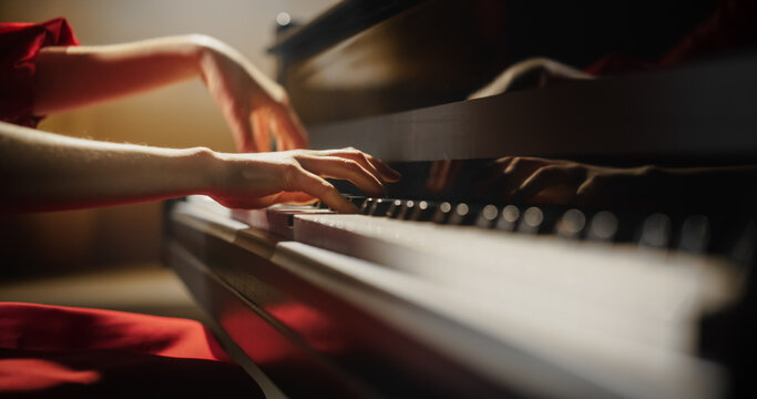 Close Up on an Anonymous Pianist Performing Classical Instrumental Music on Stage. Female Musician Using a Grand Piano to Create Beautiful, Melodic Jazz Improvisation. Hands Moving Across the Keys