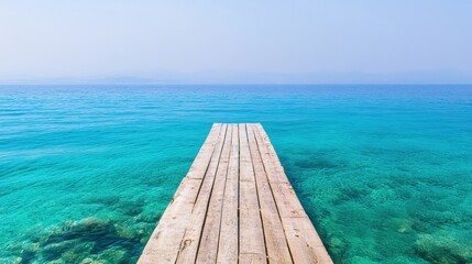 A peaceful wooden pier reaches into the serene blue ocean under a clear sky, inviting relaxation and contemplation