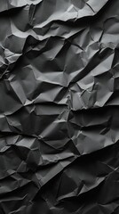 Obraz premium Close-up view of crumpled black paper creating a textured and abstract backdrop