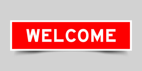 Square sticker label with word welcome in red color on gray background
