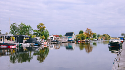 Fototapeta premium Houses on Loosdrechtse Plassen Lake with Boats, Islands and Canals. Scheendijk, Netherlands