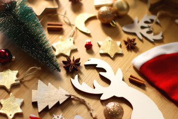 Various Christmas decorations in neutral colors on wooden background. Selective focus.