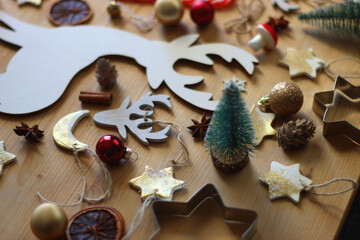 Various Christmas decorations in neutral colors on wooden background. Selective focus.