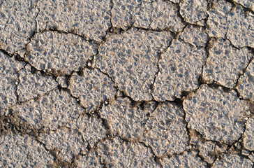 Old cracked asphalt on the road. Substrate.