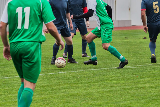 Escalation of an attack in a soccer game, one attacking player outmaneuvering several defending footballers
