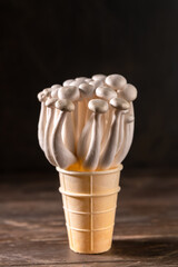 Closeup of a bunch of shimeji mushrooms on wooden background, with selective focus