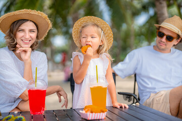 Happy family enjoying vacation on the beach together having fun on summer vacation.