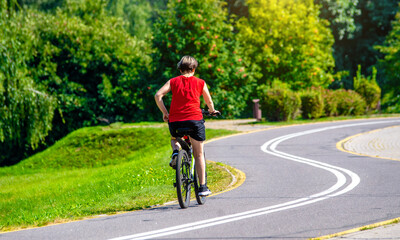 Cyclist ride on the bike path in the city Park