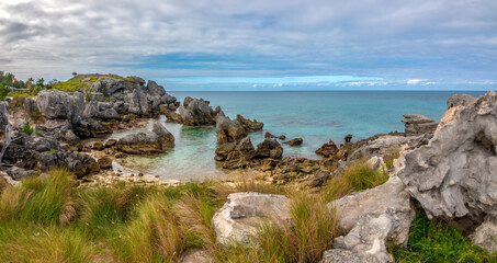 Grass fields growing among the rugged rock formations on the north coast of St. George Island, Bermuda, British Overseas Territory, UK
