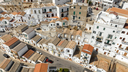 Aerial view of white houses, buildings and apartments in the historic center of Pisticci, in the province of Matera, Basilicata. It is a small hill town in southern Italy.