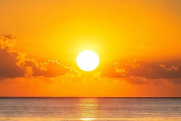 The golden sun rises and sets over the ocean, painting the sky with hues of day over the horizon.