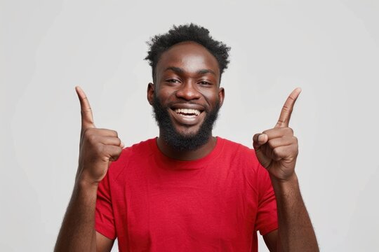 Confident young African American man in red shirt smiling proudly.
