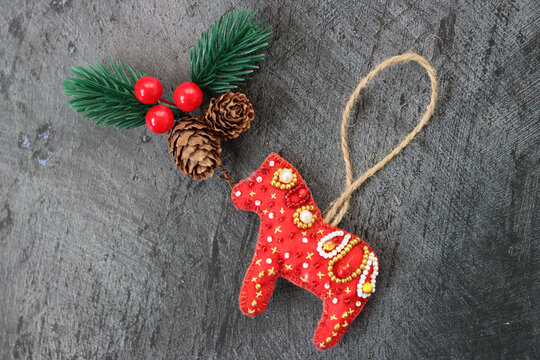 Handmade Christmas decoration  made of felt and seed bead. Black background with space for text. 