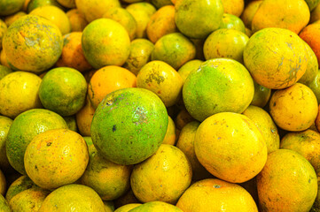 Orange citrus fruits in a fruit shop basket. Focus on fruit, noisy, exposure, similar others