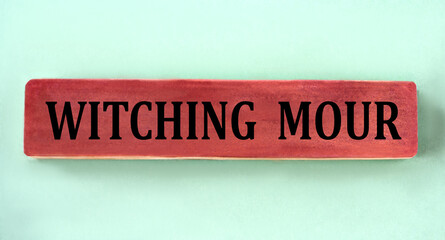 WITCHING HOUR - words on brown wooden block on mint background