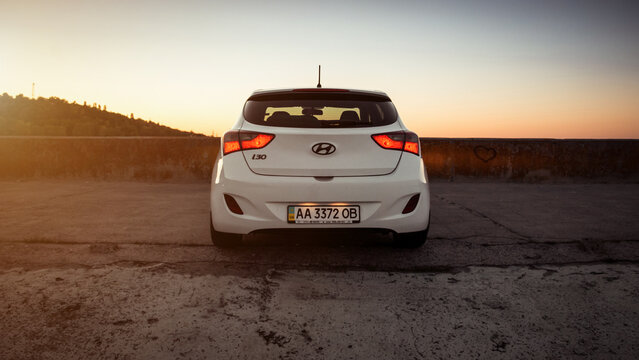white Hyundai i30 in parking lot at sunset. Rear view of a korean hatchback, clear sky and hill in the background. Kyiv region, Ukraine - May 06 2014.