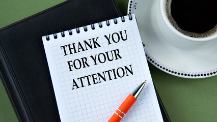THANK YOU FOR YOUR ATTENTION - words in notebook on green background with cup of coffee