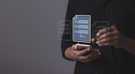 Young man with smartphone mobile hand using a pen touching to sign a Online Business Contract, Electronic signature, Contract signing, Digital documents, Future smart contract