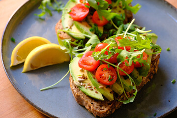 Vegan Avocado Toast with Tomatoes, Arugula, and Lemon - Healthy Breakfast