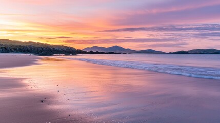 Fototapeta premium A serene beach at dawn, with soft waves gently lapping at the shore and a glowing pink and orange sky