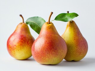 three ripe pears with green leaves