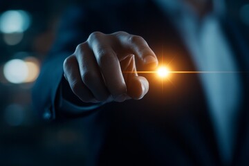 Close-up of a person's hand reaching out to touch a glowing light in a darkened environment at night