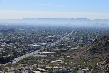 Morning haze above major Arizona city downtown of Phoenix as seen from the top of North Mountain Park hiking trails