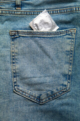 Condom on blue jeans. Safe sex