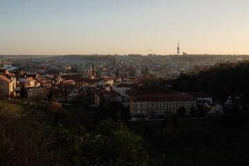 Obraz premium Prague cityscape with zizkov television tower dominating skyline during golden hour, strahov
