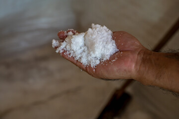 Close up hand full with traditional mountain salt processing in Nan northern Thailand