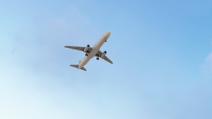ULTRA HD. Airplane flies in blue sky. Travel, tourism. Airplane takes off against the background of blue sky.  