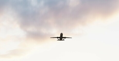 ULTRA HD. Airplane flies in sunset sky. Travel. Airplane takes off against the background of sunset sky.	