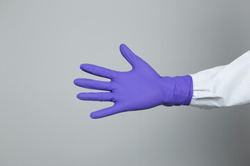 Purple nitrile gloves worn by doctor or medical worker. Doctor, nurse, sterile, surgeon, medical concept