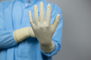 Doctor wearing nitrile gloves, isolated on grey background. medical, surgeon, sterile, pharmaceutical concept