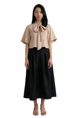 Naklejka premium A young Asian woman with shoulder-length black hair wears a peach blouse with a bow and black skirt.