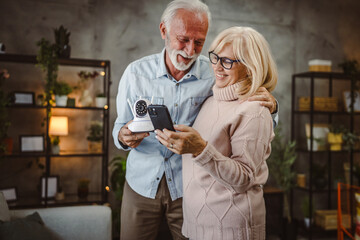 couple connect cctv security surveillance camera on cellphone at home