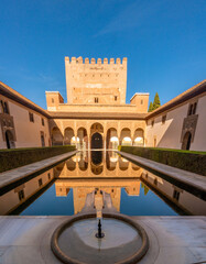 Fototapeta premium Perfectly reflecting pool in a courtyard within the ruins of the historic Nazarid Palace, the Alhambra complex, Granada, Andalusia, Spain