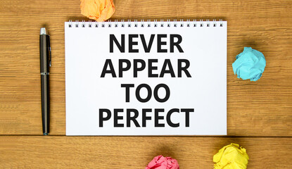 Never appear too perfect symbol. Concept words Never appear too perfect on beautiful white note. Beautiful wooden background. Black pen. Business never appear too perfect concept. Copy space.