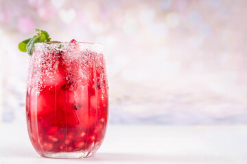 Spiced up winter berry Margarita cocktail or mocktail with orange, cranberry, pomegranate mint and crushed ice, Sweet non-alcohol or alcohol vodka drink for Christmas party