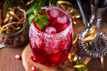 Spiced up winter berry Margarita cocktail or mocktail with orange, cranberry, pomegranate mint and crushed ice, Sweet non-alcohol or alcohol vodka drink for Christmas party