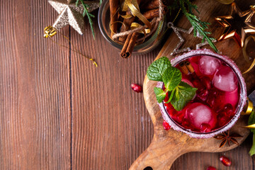Spiced up winter berry Margarita cocktail or mocktail with orange, cranberry, pomegranate mint and crushed ice, Sweet non-alcohol or alcohol vodka drink for Christmas party
