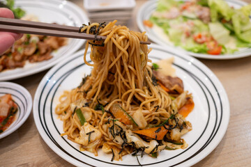 Delicious stir-fried noodles experience cozy restaurant food indoor dining close-up culinary delight